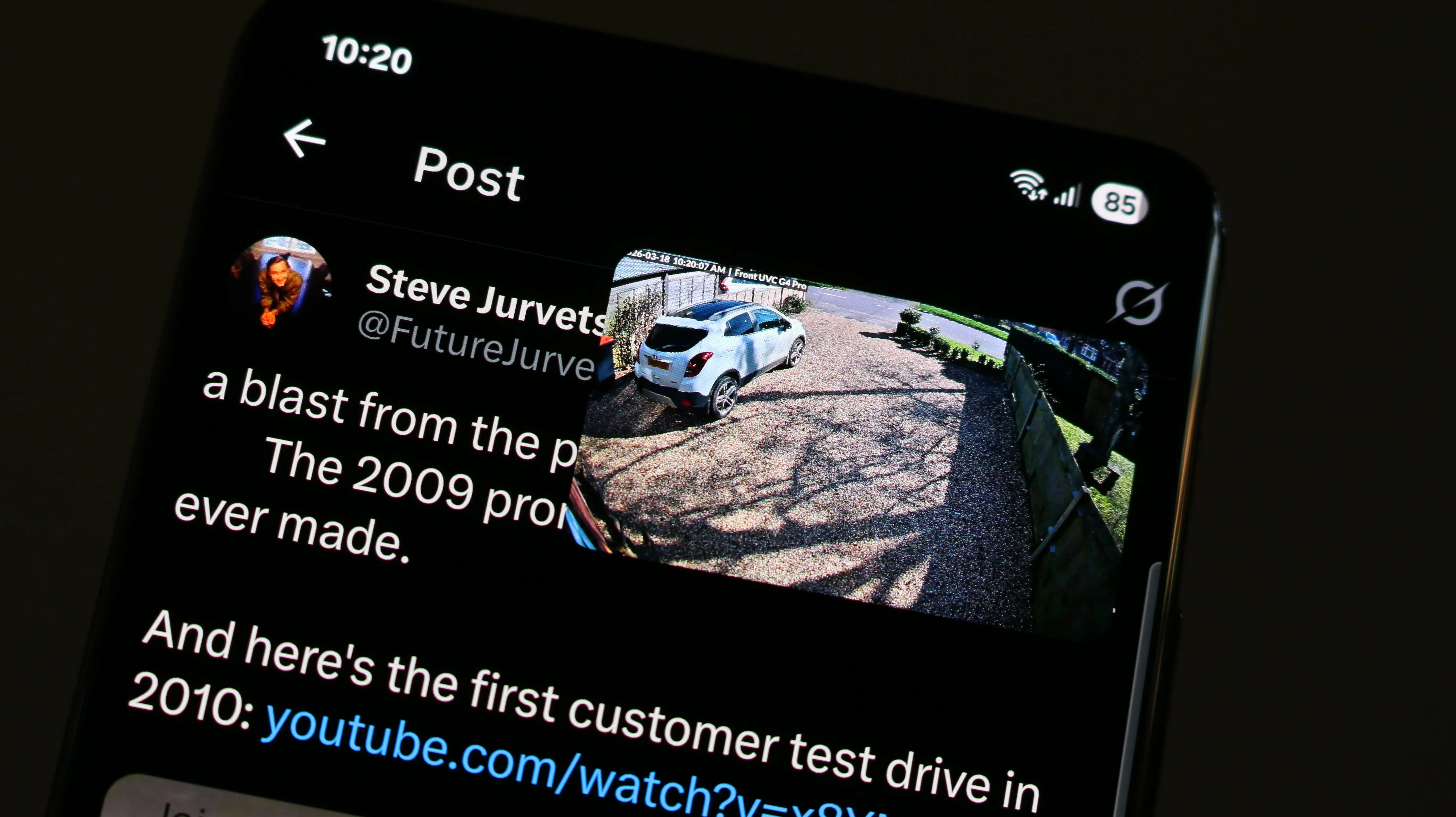 Phone showing Twitter with scOS camera feed floating as picture-in-picture